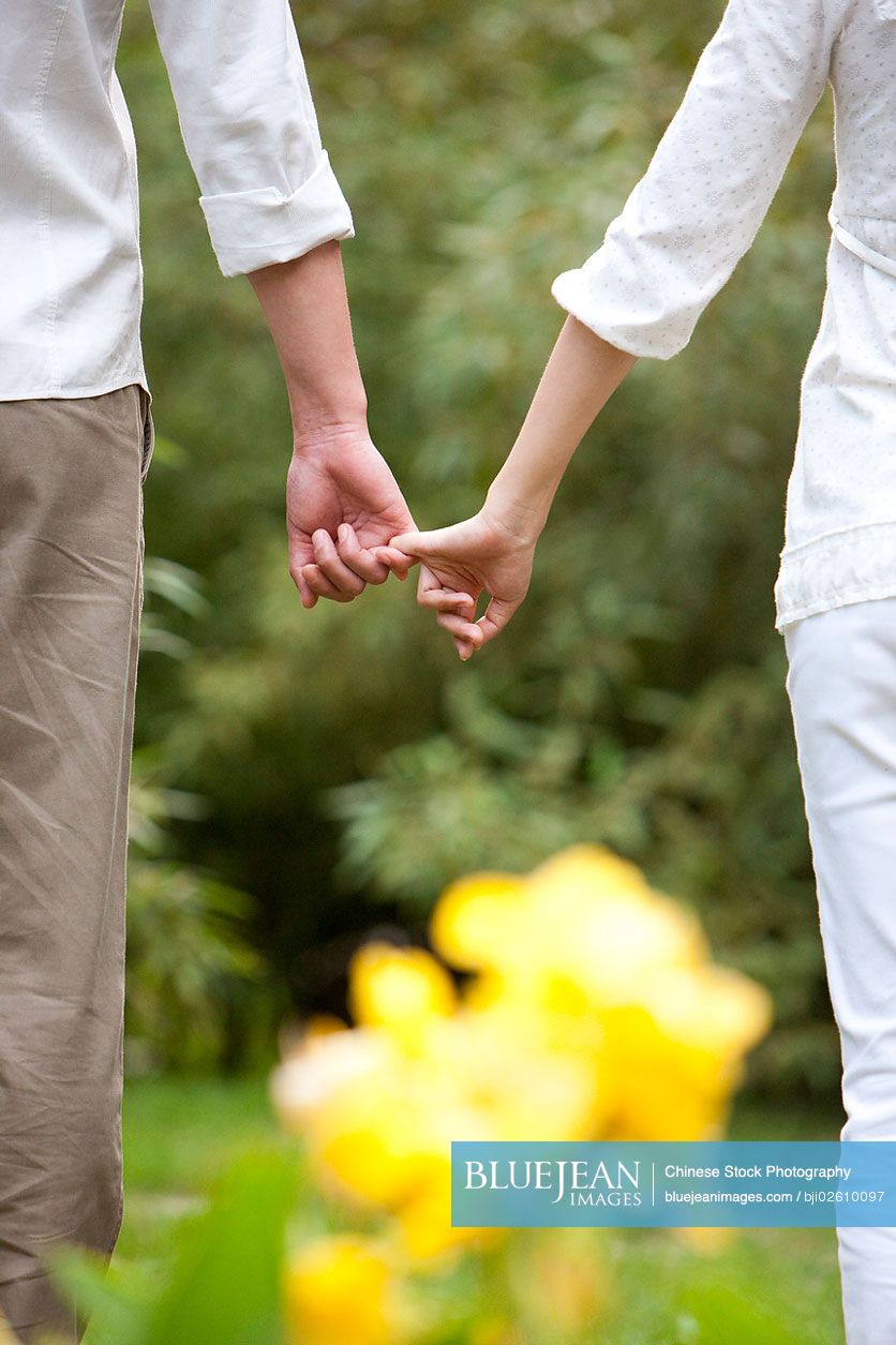 Young Chinese couple hand in hand