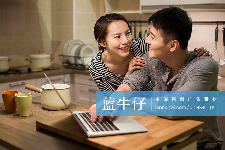 年轻情侣在厨房使用笔记本电脑-蓝牛仔影像-中国原创广告影像素材