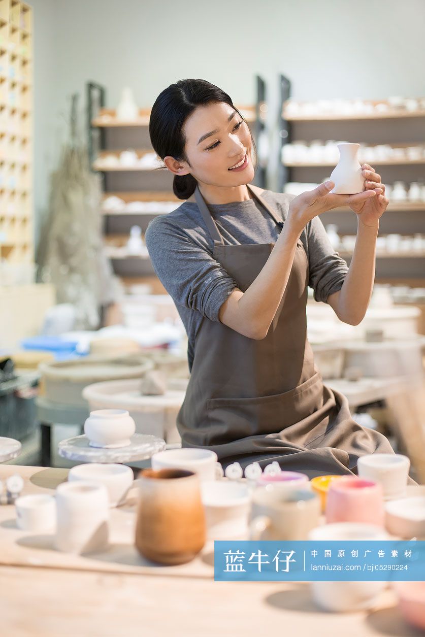 年轻陶艺师检查陶胚