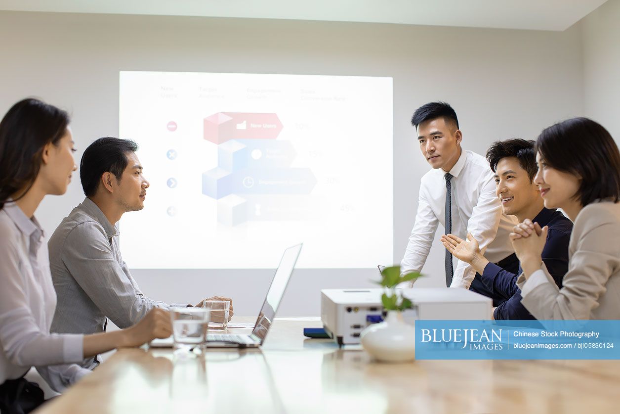 Chinese business people having meeting in board room 