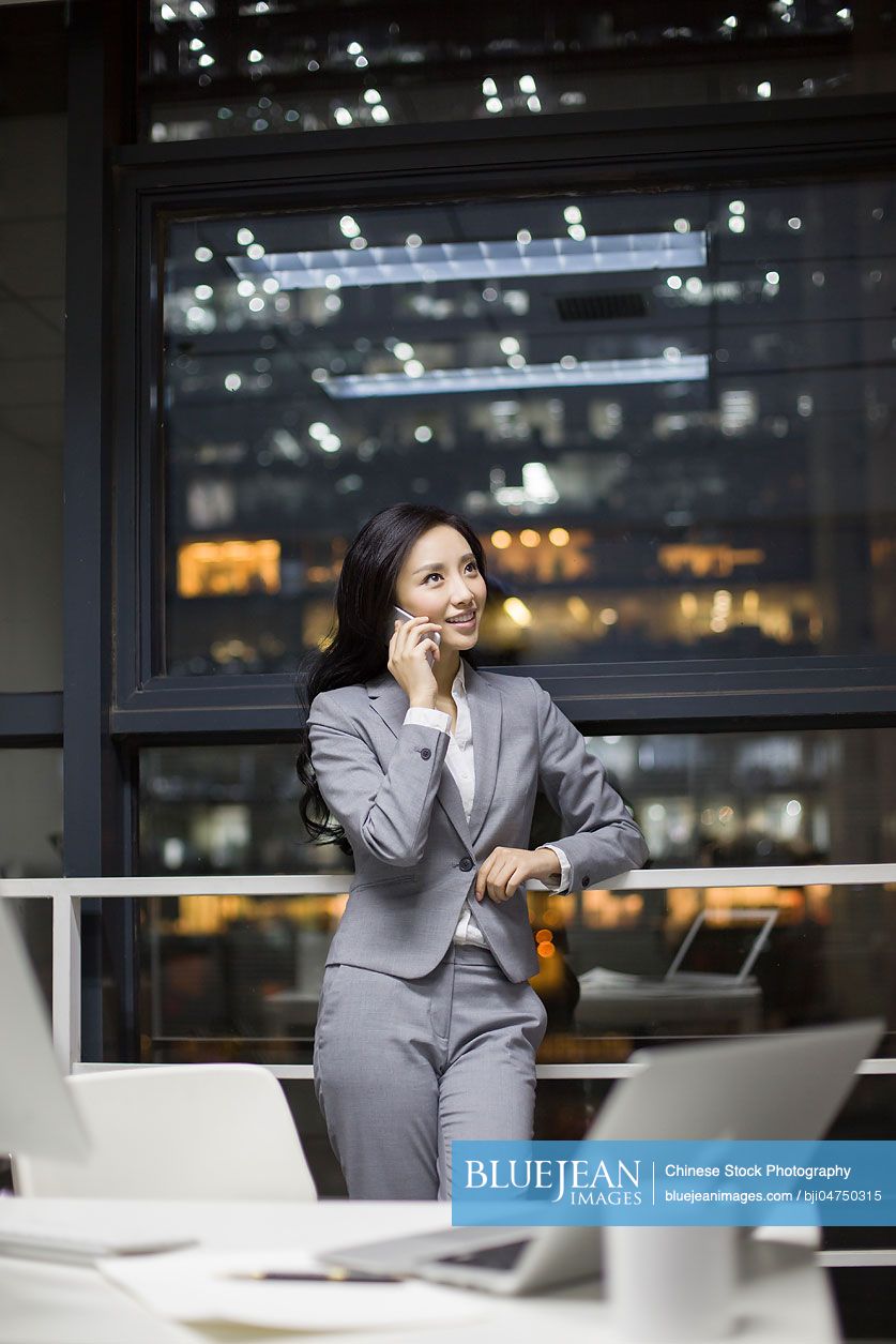 Chinese businesswoman talking on the phone in office