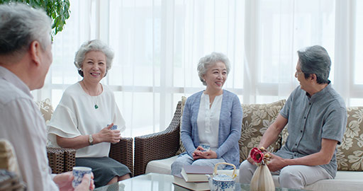 Happy senior Chinese friends drinking tea in living room,4K