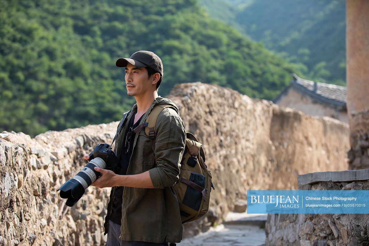 Chinese photographer taking photos in village