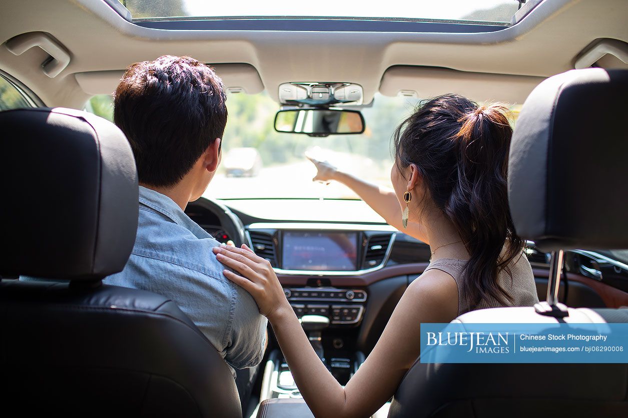 Young Chinese couple enjoying road trip