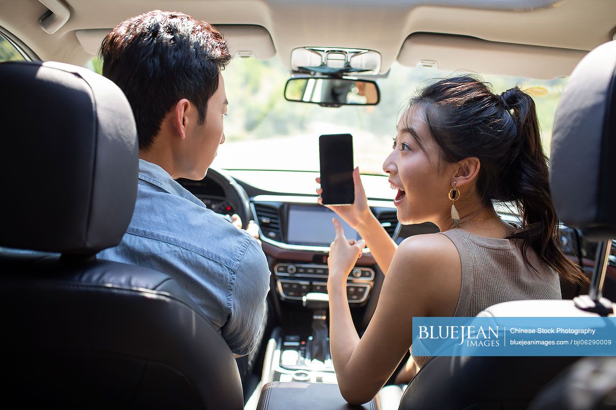 Young Chinese couple enjoying road trip