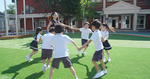 Chinese teacher and students playing in kindergarten playground,4K