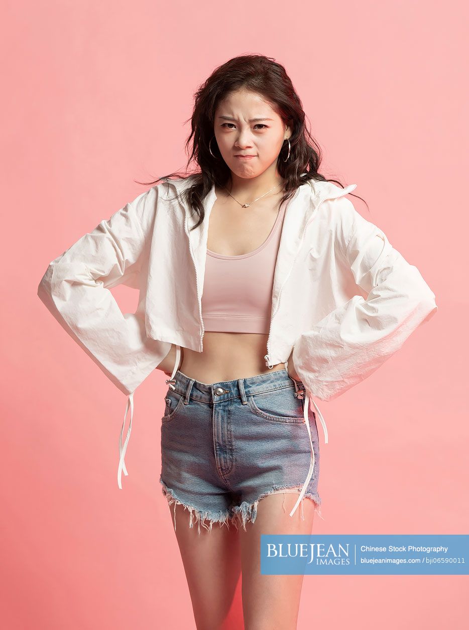 Studio shot of angry young Chinese woman