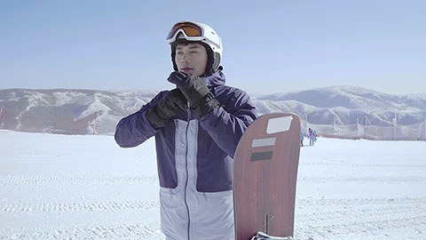 Young Chinese man with snowboard on the snow,4K