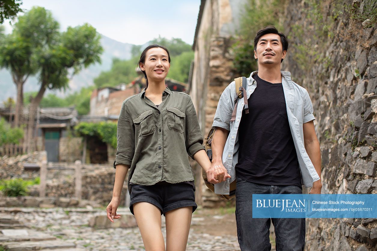 Young Chinese couple hiking in village