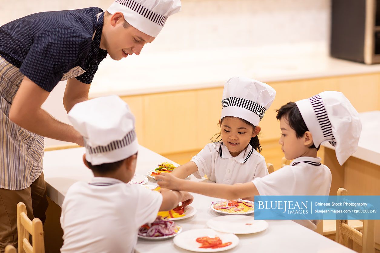 Children learning cooking in classroom