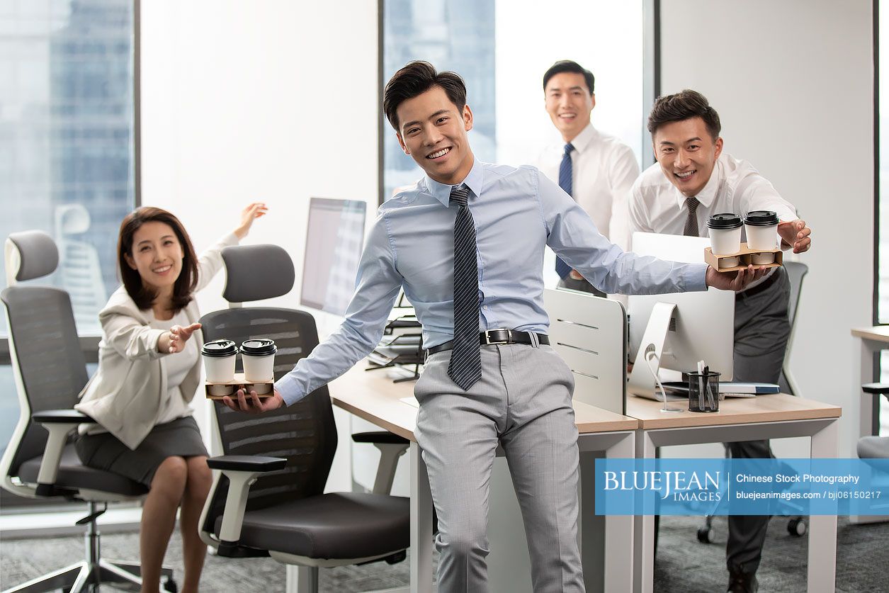 Chinese business people drinking coffee in office