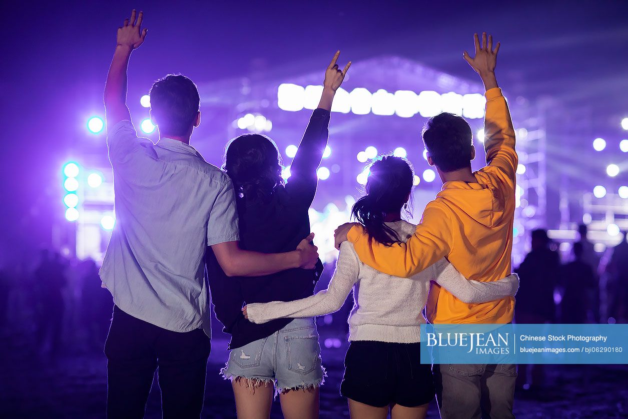 Happy young Chinese friends at music festival