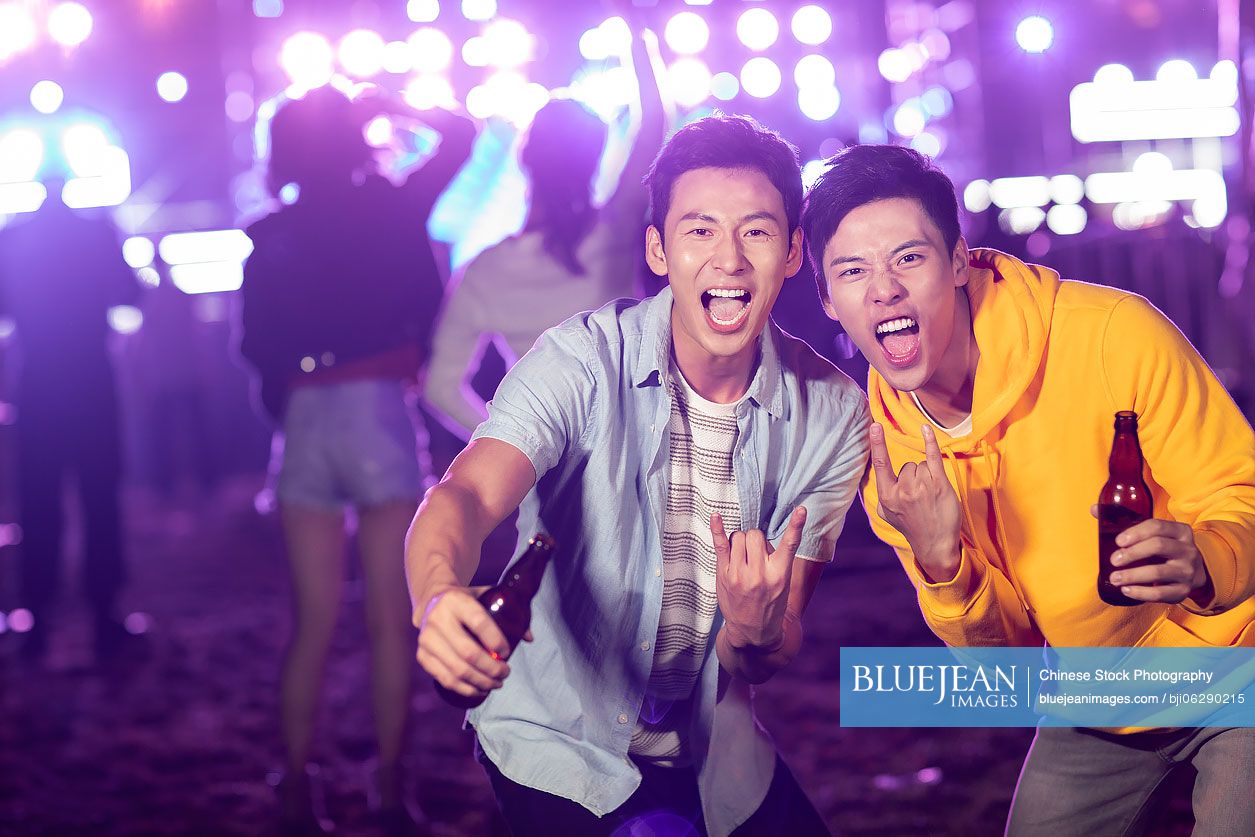 Happy young Chinese friends at music festival