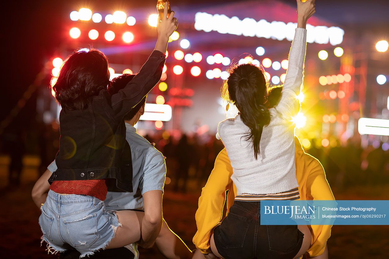 Happy young Chinese friends at music festival