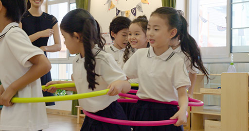 Chinese teacher and children playing games in kindergarten classroom,4K