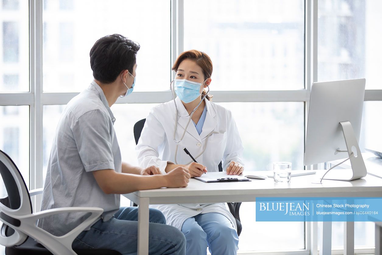 Chinese doctor talking with patient