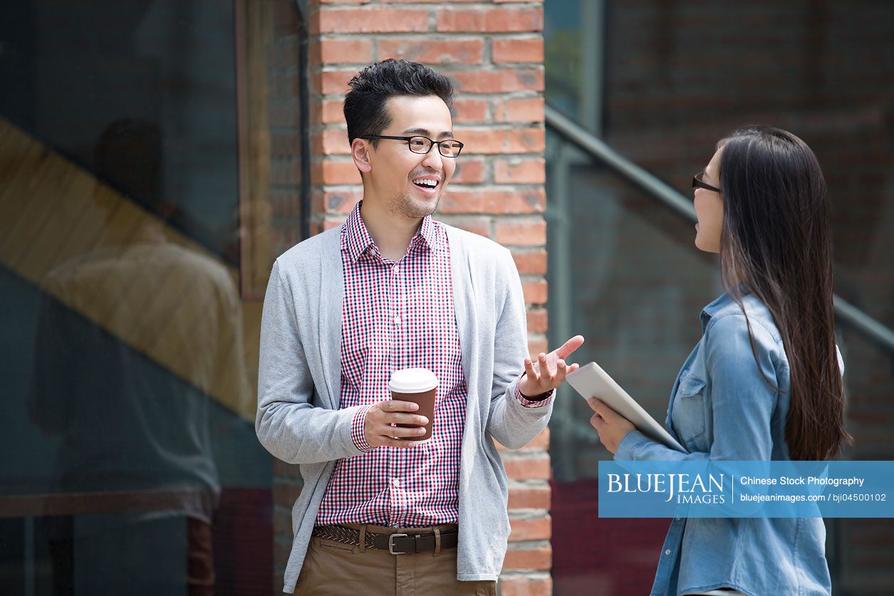 Chinese business partners in cultural industry talking