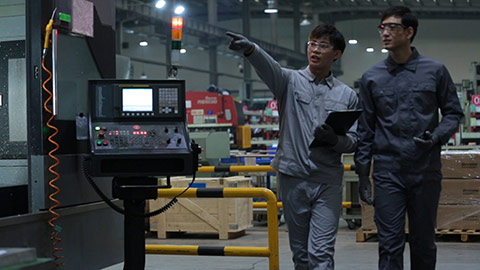 Young Chinese engineers inspecting in factory,HD