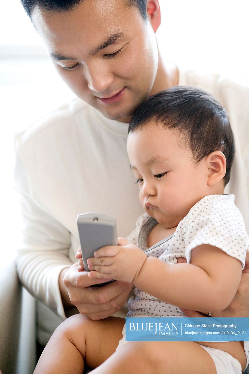 chinese-man-with-infant-high-res-stock-photo-for-download