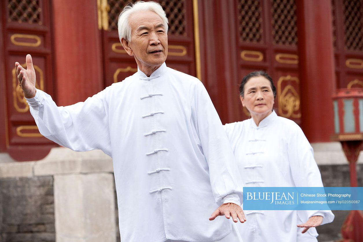 Senior Chinese couple practicing Tai Chi in Temple of Heaven