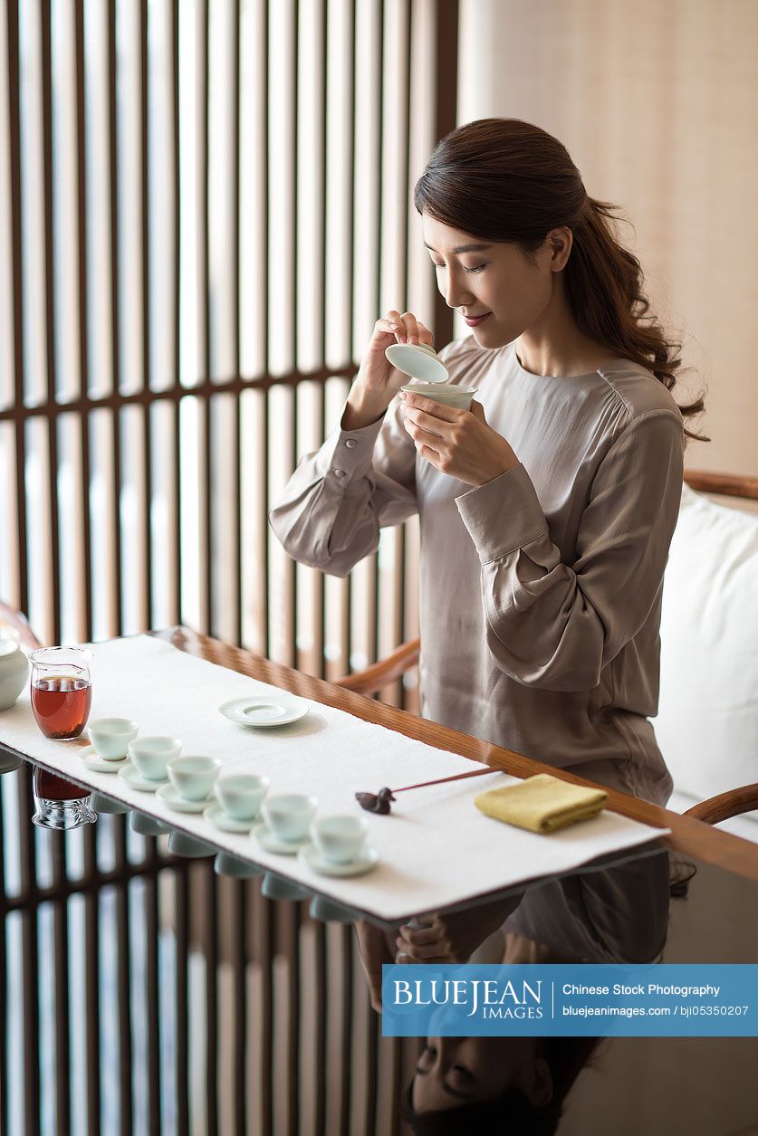 Young Chinese woman drinking tea