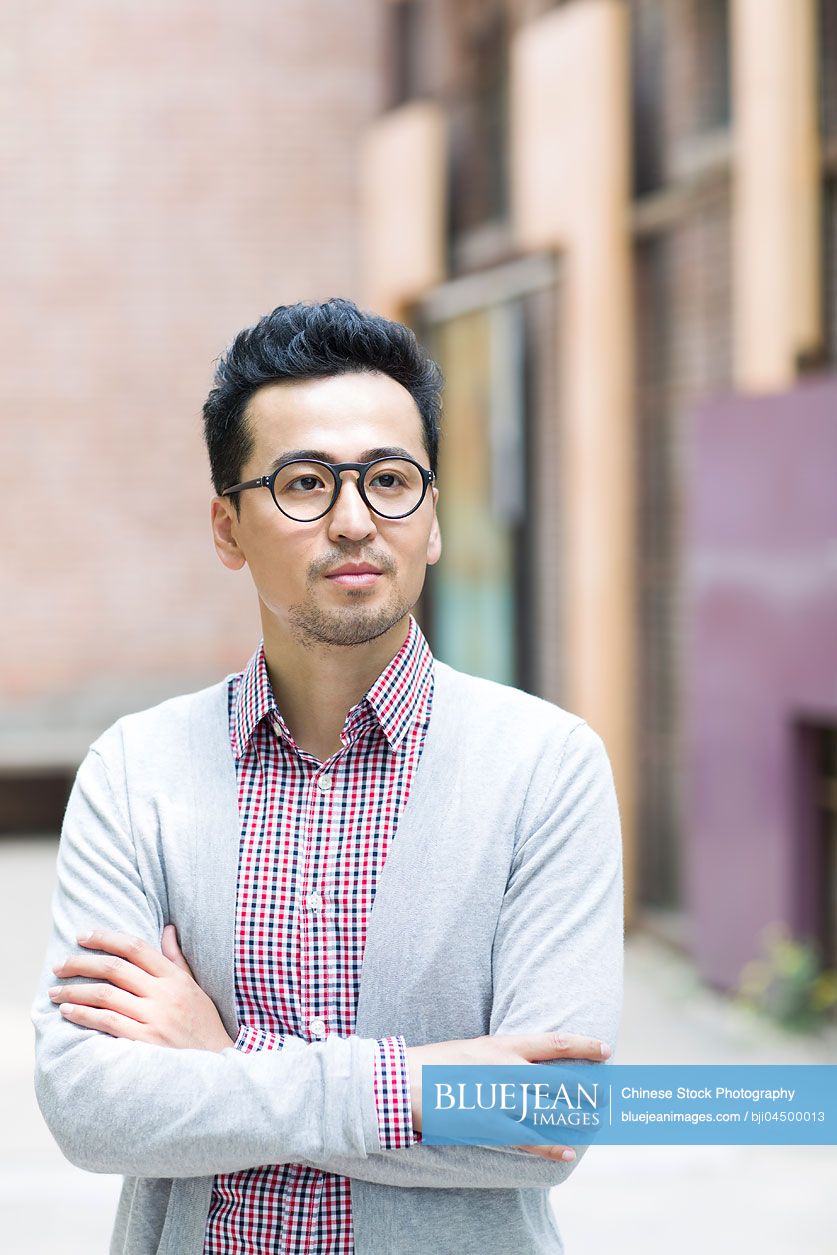 Mid adult Chinese man thinking