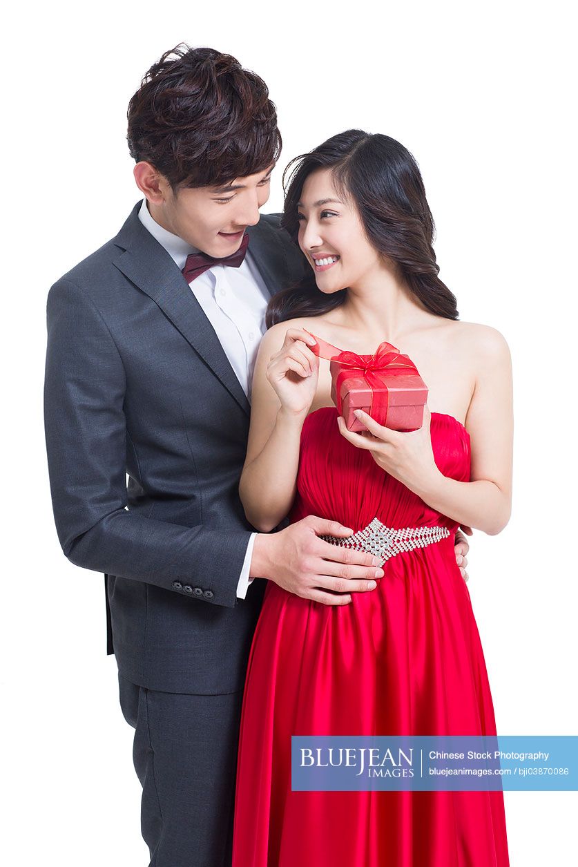 Young Chinese man giving girlfriend gift