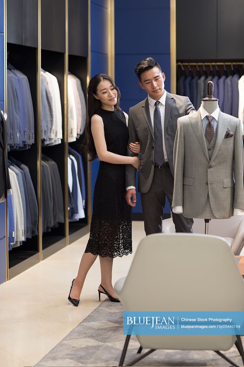 Young Chinese couple shopping in a men's wear store