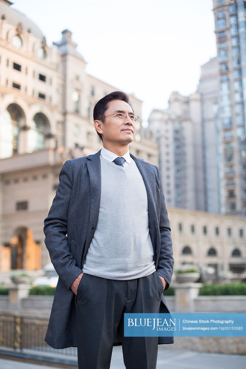Confident Chinese businessman looking at view