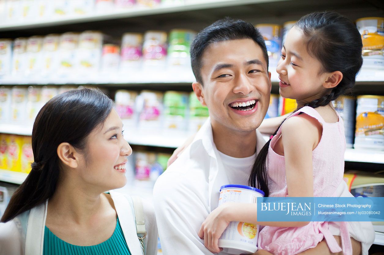 Chinese family shopping in supermarket