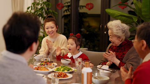 A son gifting his father a fine bottle of spirits to celebrate Chinese New Year