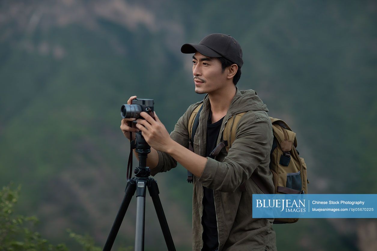 Chinese photographer taking photos outdoors