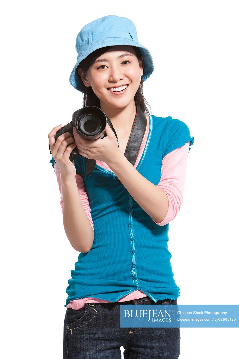 Portrait of a young Chinese woman holding a camera