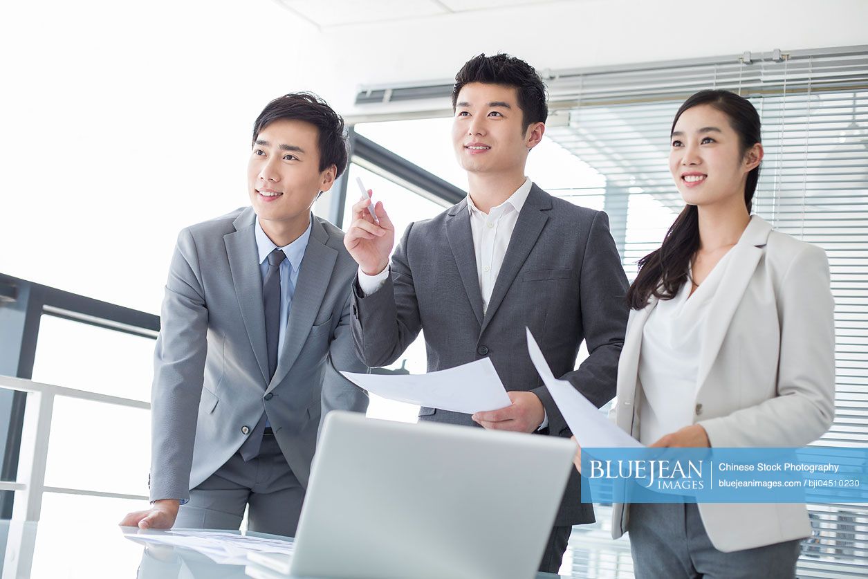 Young Chinese business person talking in meeting room