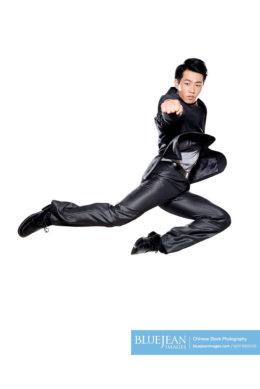 Chinese businessman punching in the air on white background