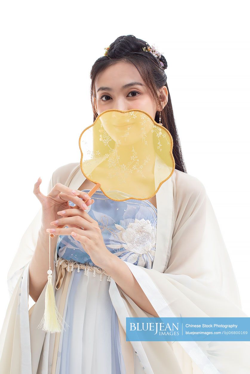 Beautiful young Chinese woman holding a round fan