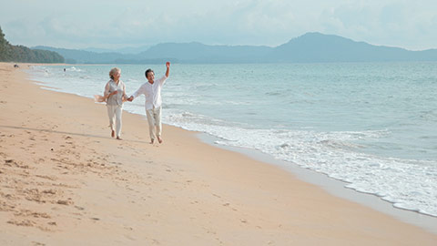 Happy senior Chinese couple on beach,4K