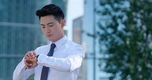 Confident young Chinese businessman checking the time,4K