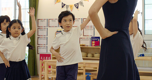 Chinese teacher teaching children to dance in kindergarten classroom,4K