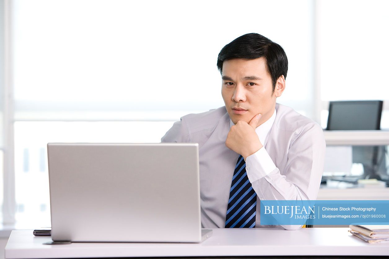 Chinese office worker at his desk