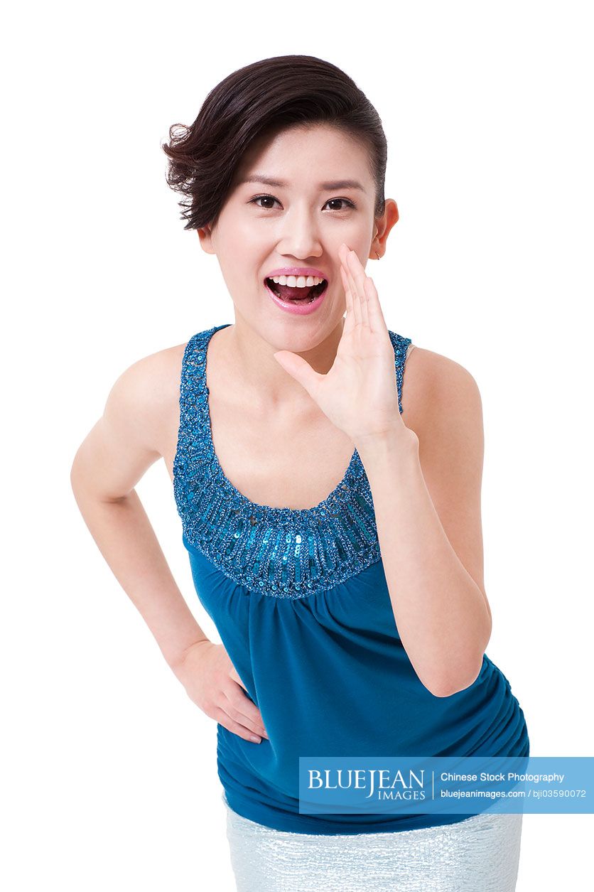 Cheerful young Chinese woman shouting