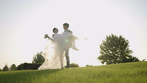 Wedding groom picking up bride