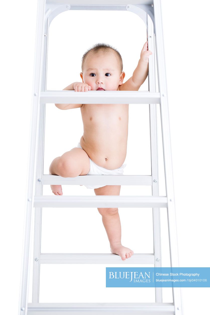 Cute Chinese baby boy climbing ladder