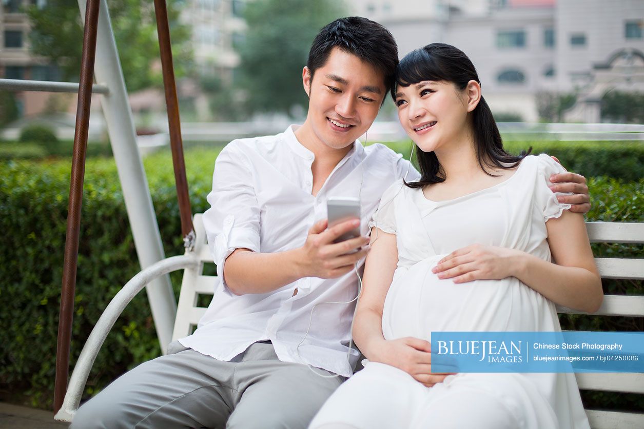 Young Chinese man and pregnant wife