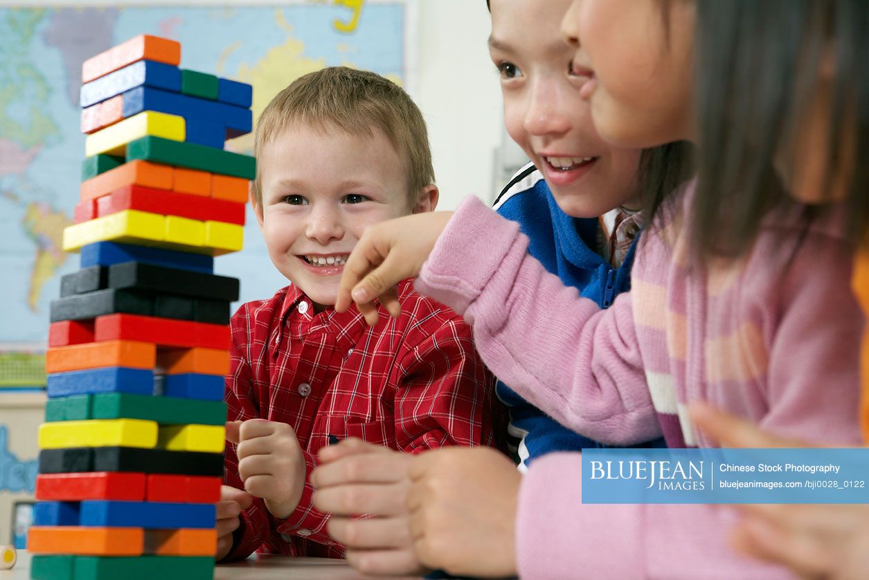 Children and tower of blocks