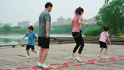 A young family works out in the park, staying active and healthy