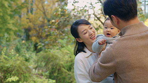 Young Chinese parents spending time with their baby