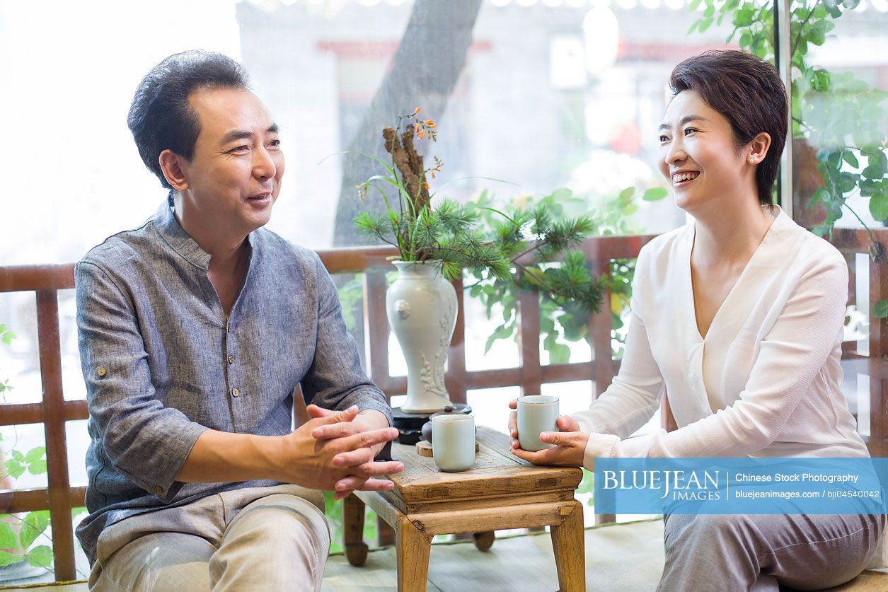 Chinese friends drinking tea and talking in tea room