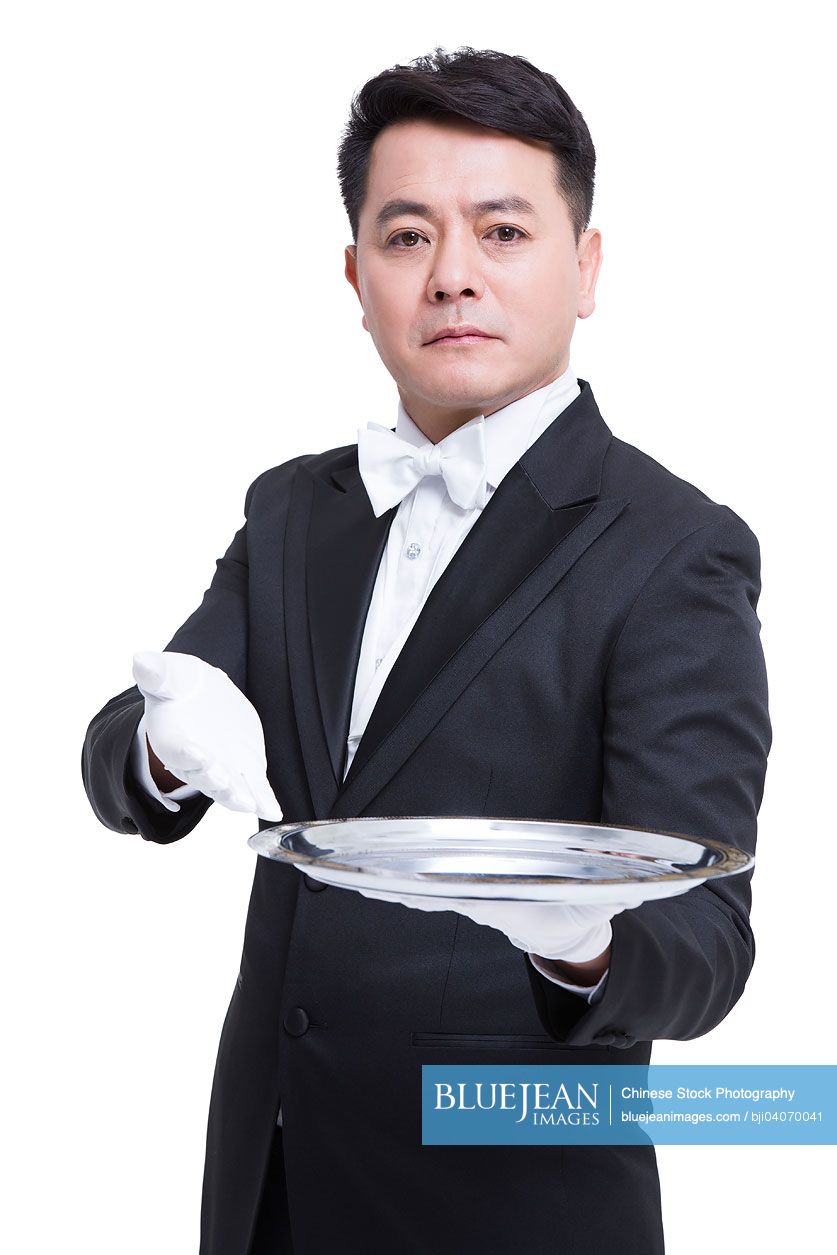 Happy Chinese waiter with serving tray