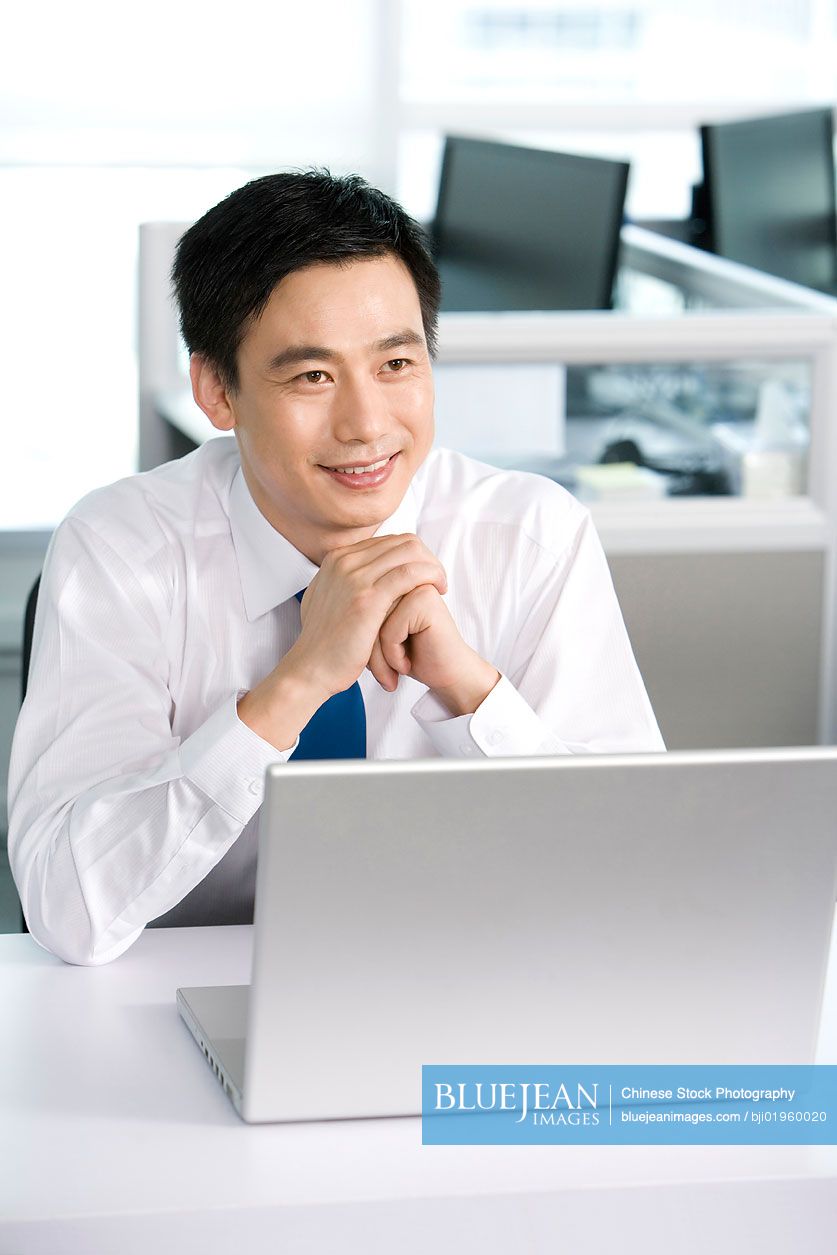 Chinese office worker at his desk